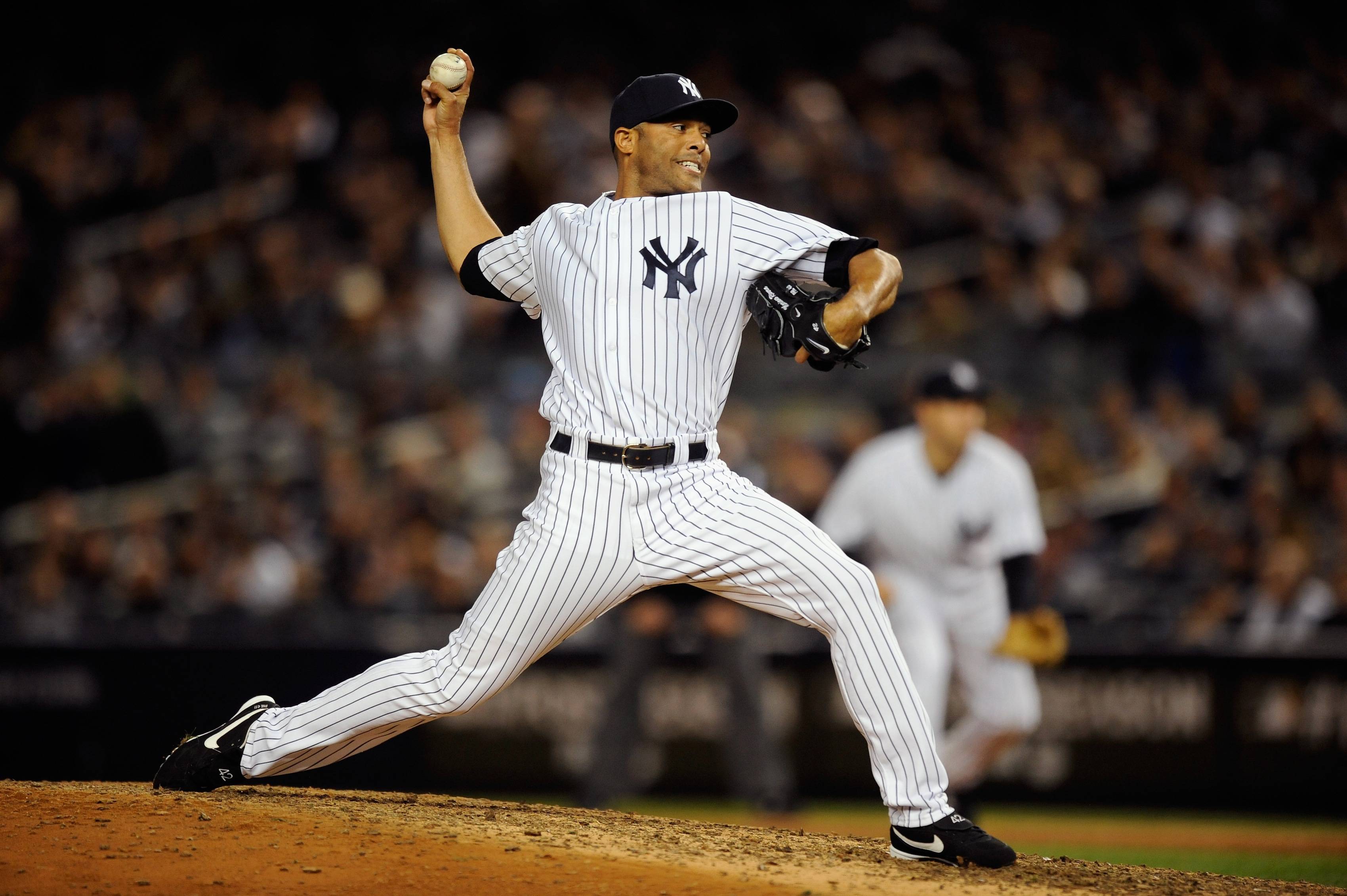 Mariano Rivera, often responsible for closing out Yankees games, prepares a pitch on the mound.