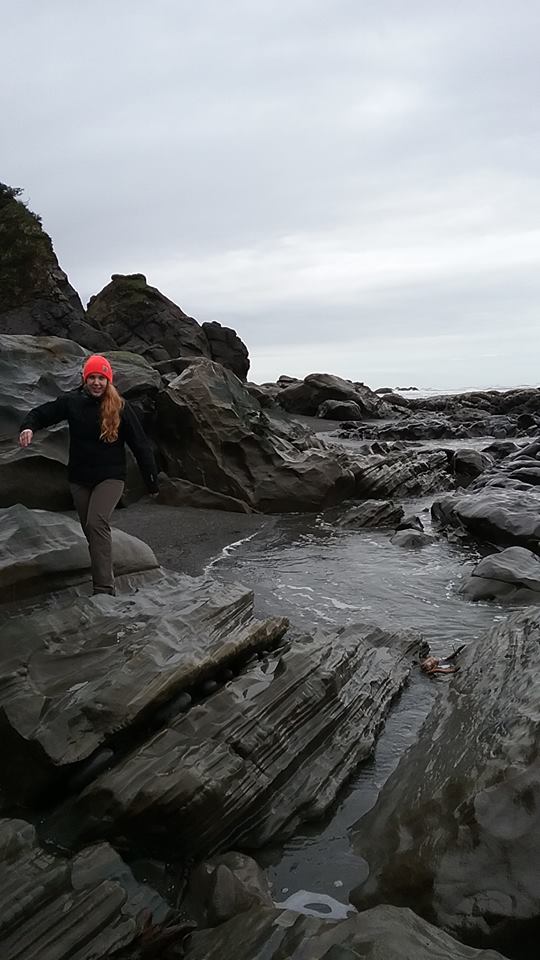 Kara checking out rocks on the coast.